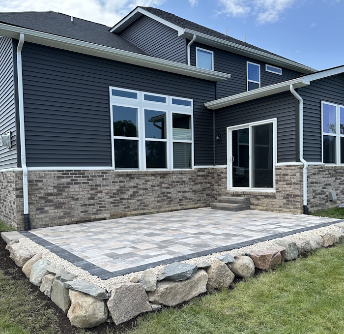 Rock Guys crew installing a brick paver patio in Washtenaw County, Michigan